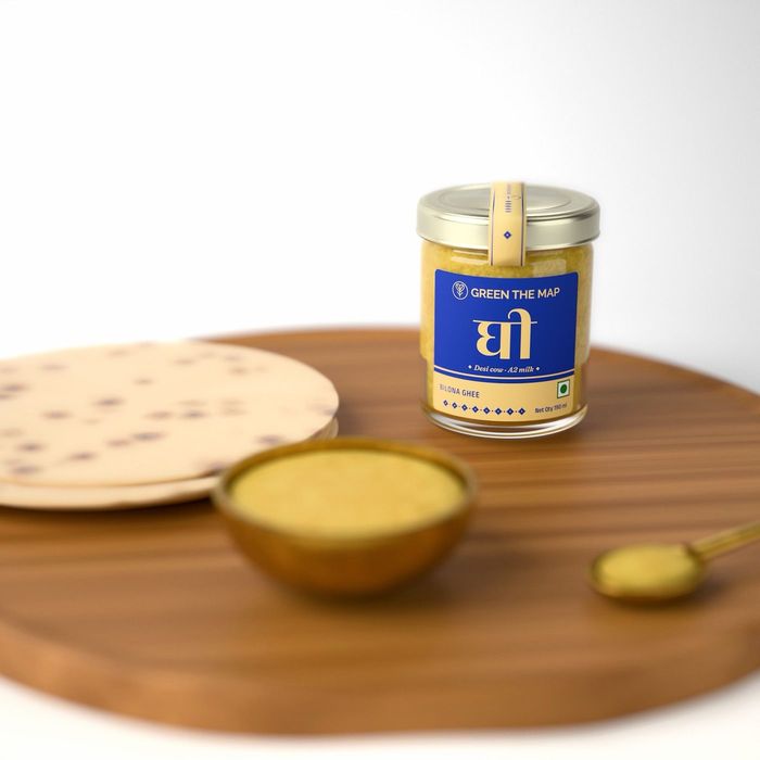 Bilona ghee in a brass bowl beside warm rotis