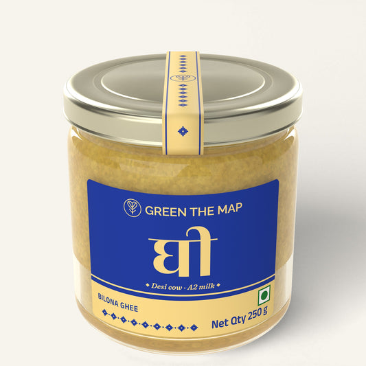 Bilona ghee 250 g in a glass jar with a blue label and a champagne gold cap, on a plain off-white background.