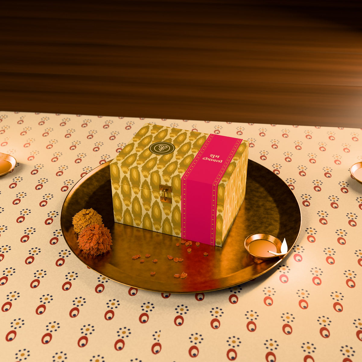 The 2-jar gift box presented on a brass thali with a lit diya and marigolds.