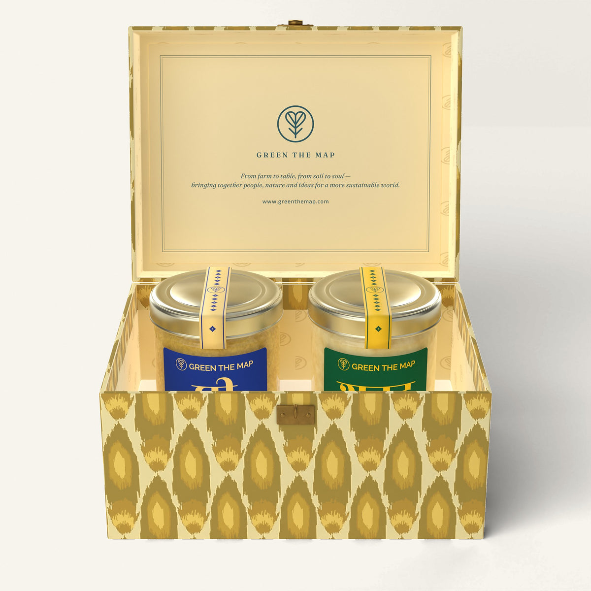 The open Jyoti 2-jar gift box with ghee and honey jars, on off-white.