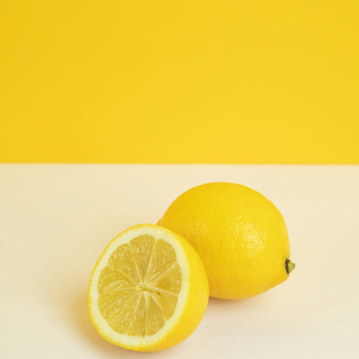 A lemon, whole and halved